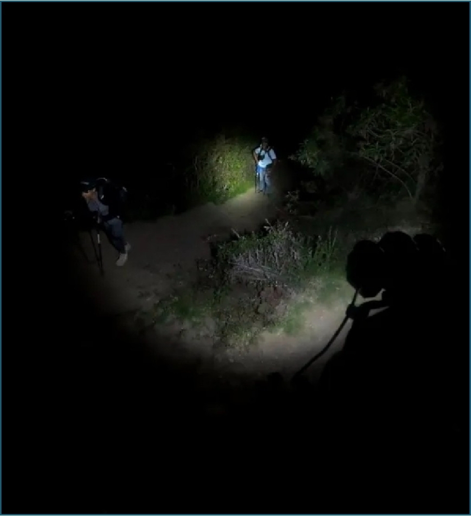 Man and woman hiking the Inca Trail to Machu Picchu at night.