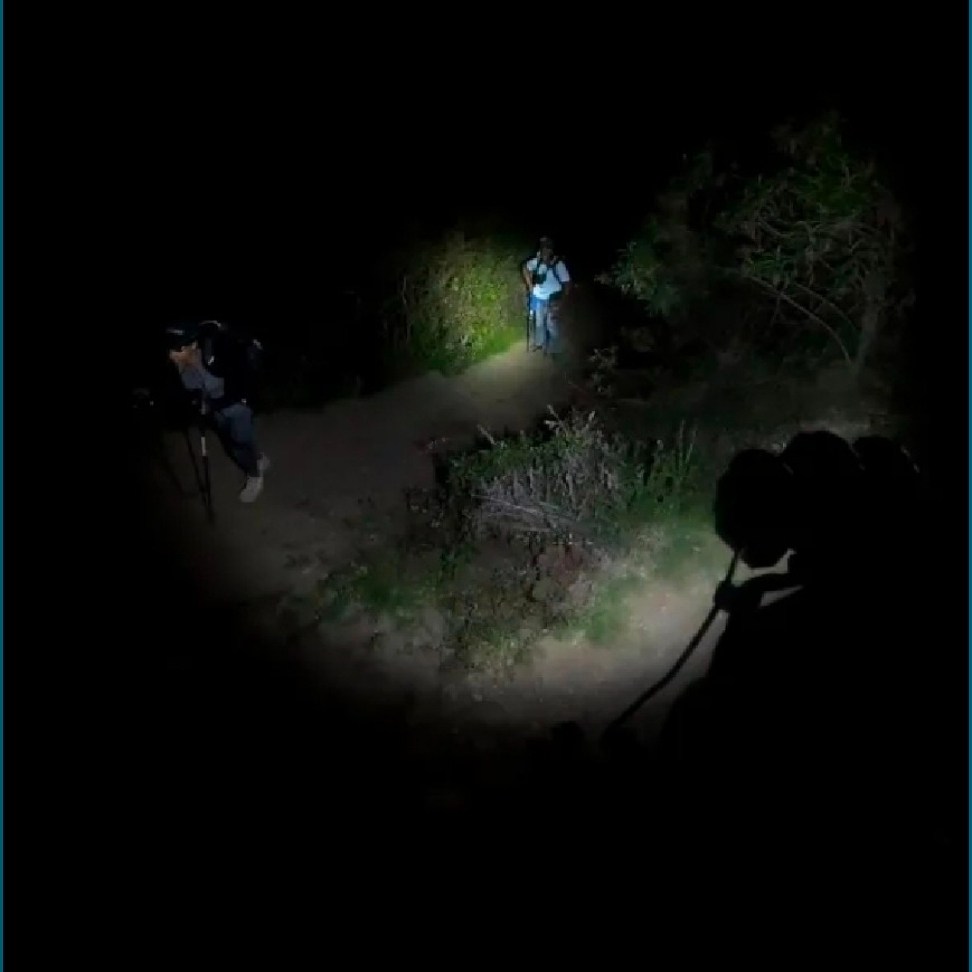 Man and woman hiking the Inca Trail to Machu Picchu at night.
